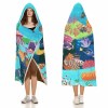 Cloak Hooded Blanket featuring an underwater coral and fish scene, crafted in Arctic Velvet for cozy lounging.