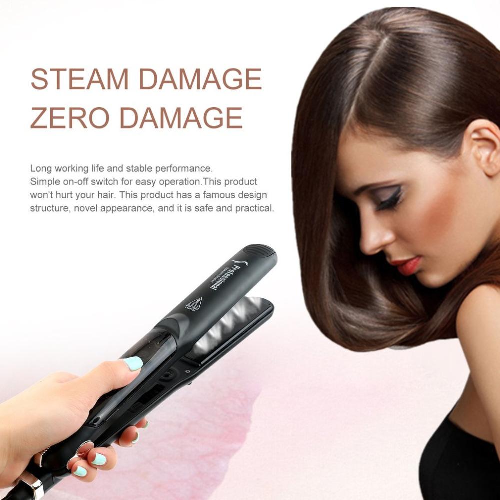 Woman gliding black steam straightener through brown hair