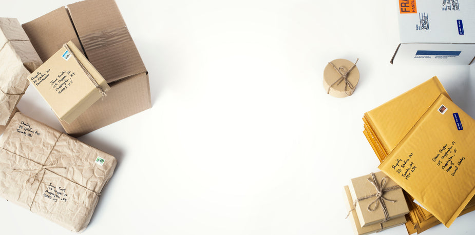 A variety of labeled cardboard boxes, padded envelopes, and wrapped packages arranged neatly on a white surface, prepared for fulfillment by an EPROLO branded dropshipping store.