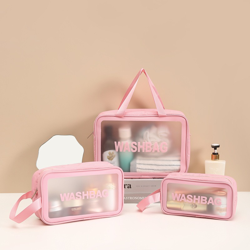 A set of three pink, semi-transparent toiletry washbags filled with cosmetics and skincare products arranged neatly on a tabletop, showcasing one of the best EPROLO summer dropshipping products.