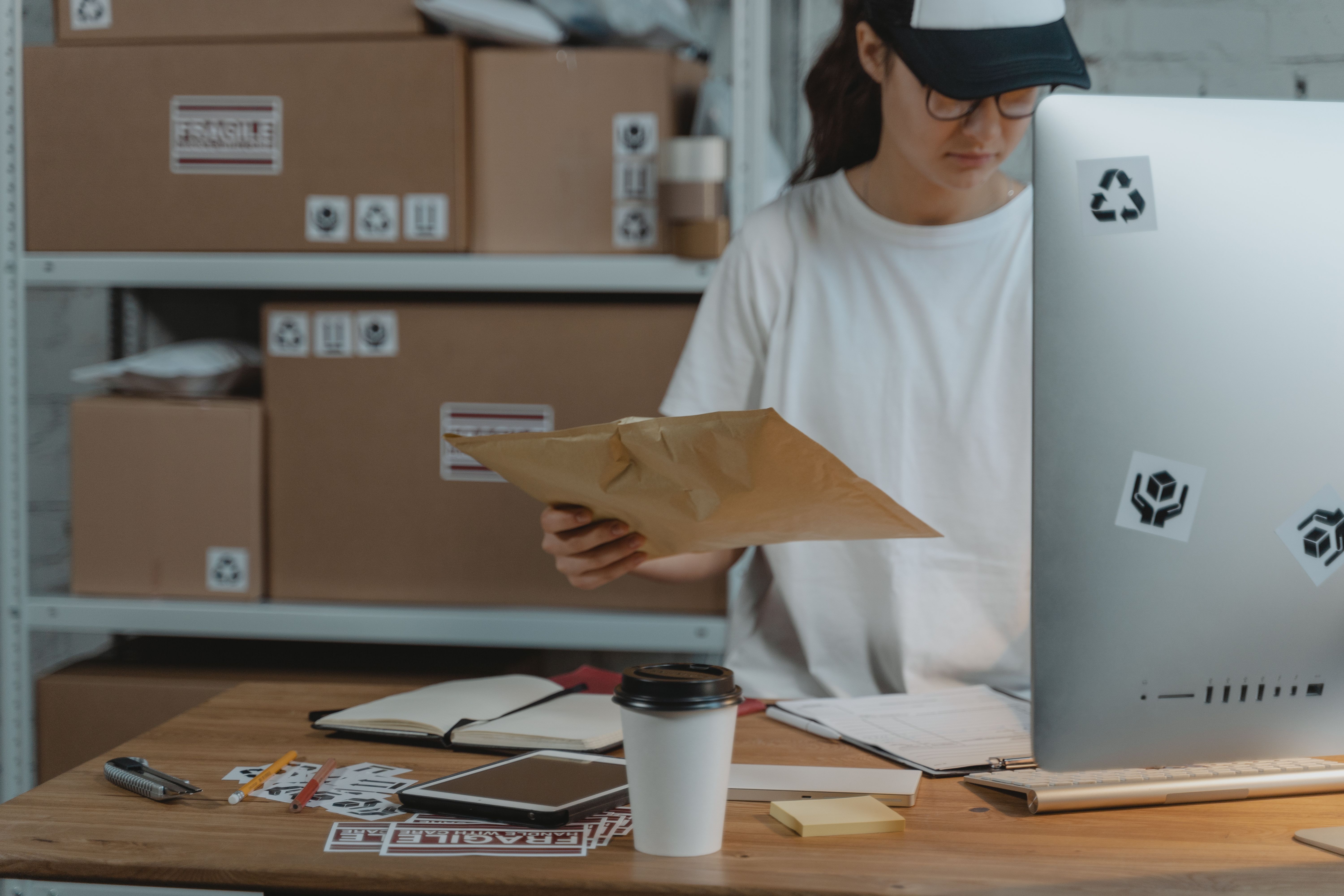 A worker checking a shipping envelope to learn how to start ai dropshipping with EPROLO automated fulfillment.