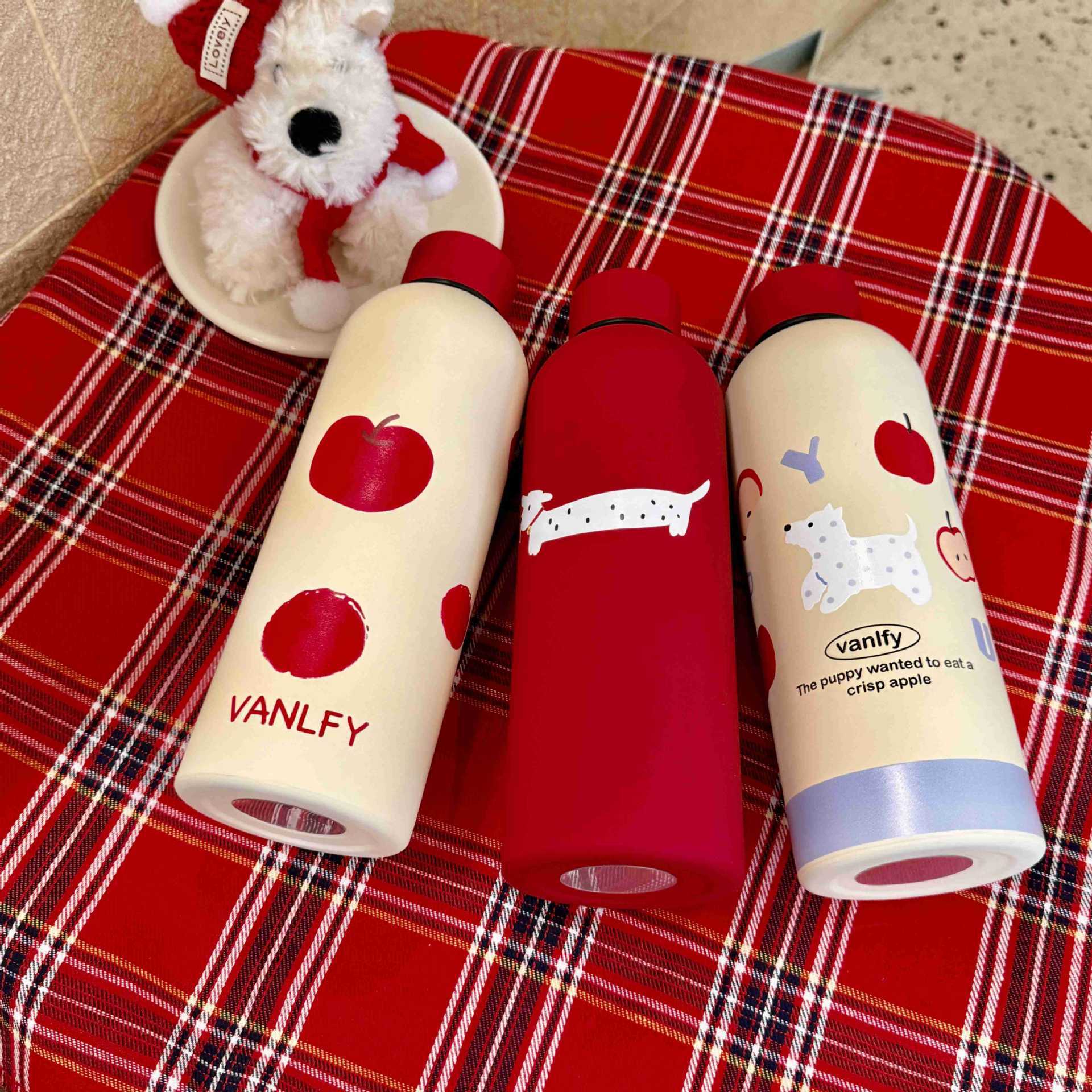 Displaying cute puppy insulated water bottles on a tablecloth, showcasing high profit margin products from EPROLO.