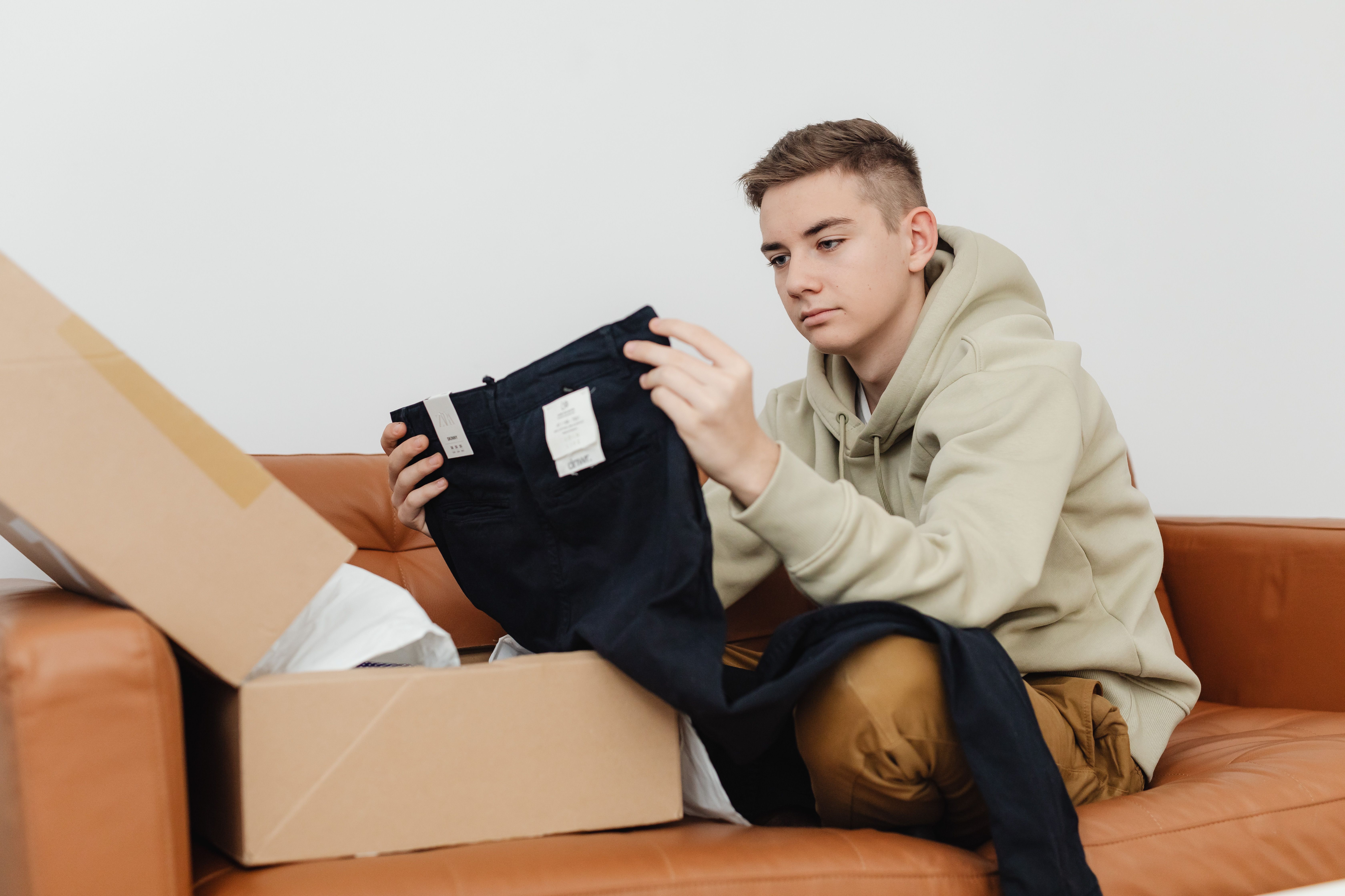 A customer performing dropshipping product inspection on apparel delivered from an EPROLO parcel.