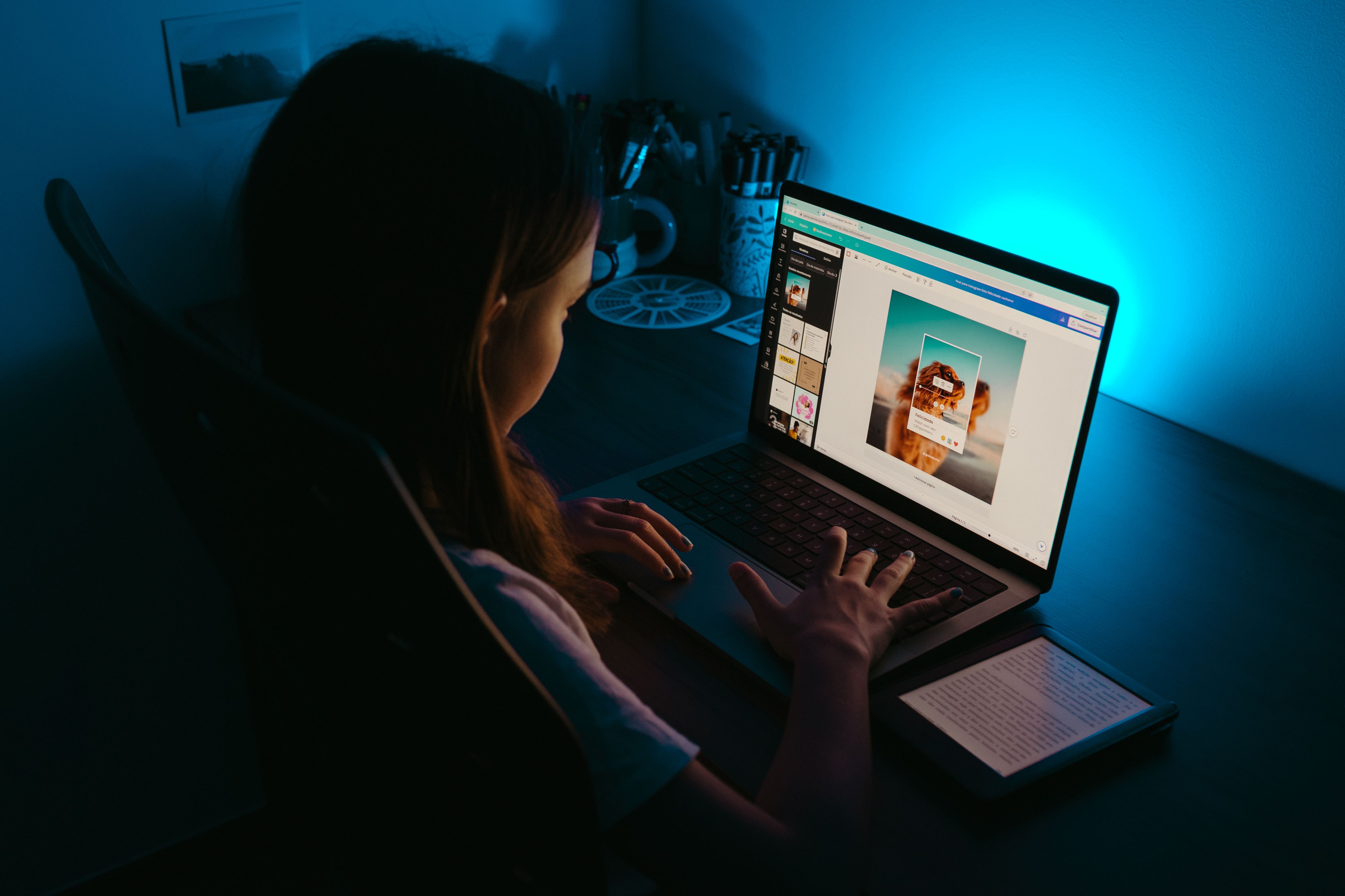 A woman developing small business ideas by designing digital graphics on a laptop.