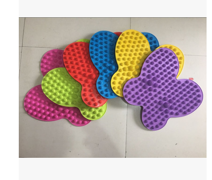 Six colorful butterfly-shaped reflexology mats in vibrant pink, red, blue, yellow, purple, and green, showing the full interchangeable product range