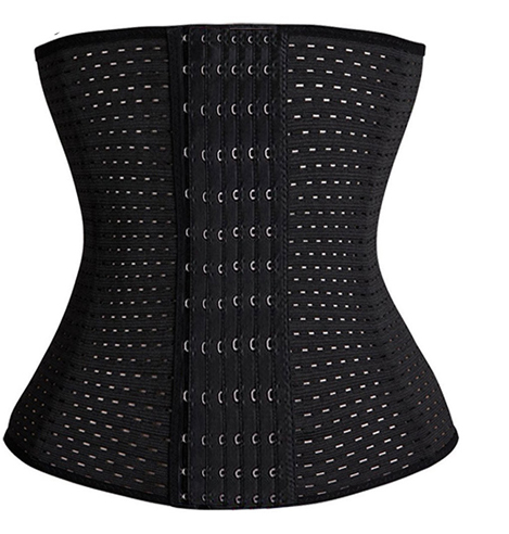 Black mesh waist trainer corset on light cork board with smooth river pebbles and soft coral accents.