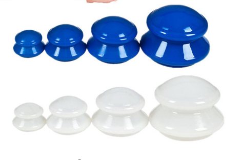Complete 4-piece silicone cupping set in blue and white on warm travertine stone