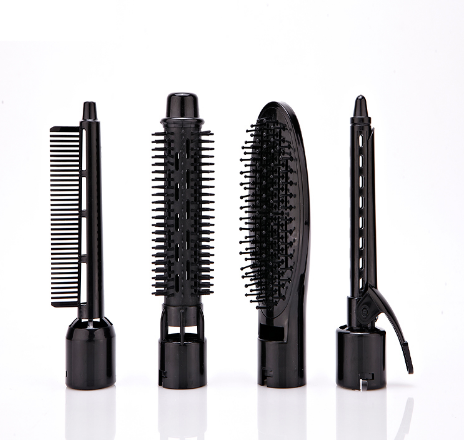 Four black interchangeable attachments for different styling tasks