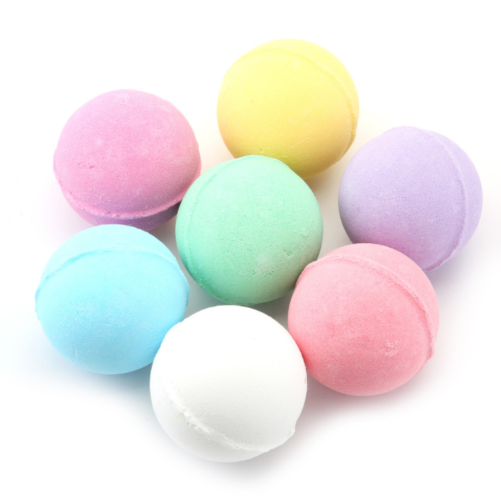 Seven assorted pastel bath bombs arranged in a cluster showing full color range