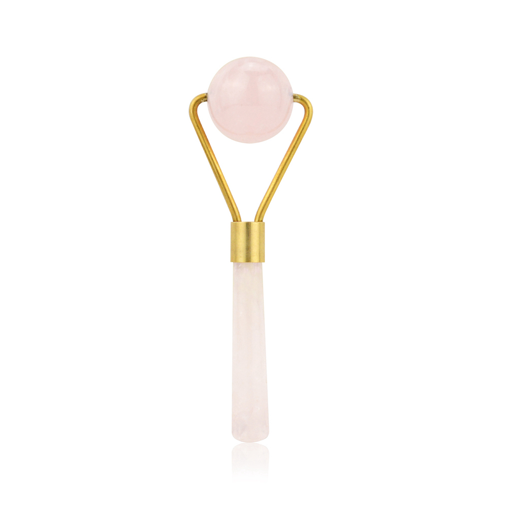 Spherical rose quartz roller head with V‑shaped handle mount, symbolizing the turning point