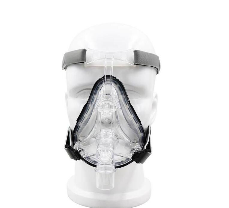 Full frontal view of silicone mask on mannequin head, showing nasal and mouth interface with gray head straps