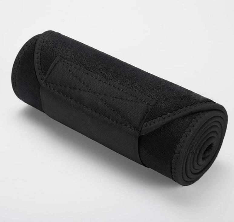 All‑black belt tightly rolled into a small disc, held in a hand