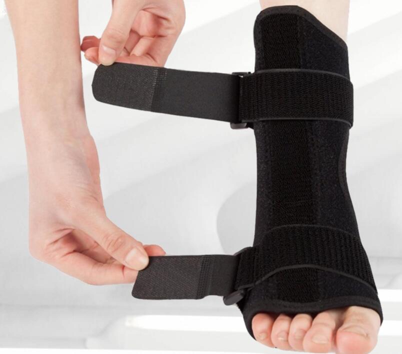 Close-up of hands adjusting velcro strap on foot to achieve therapeutic stretch