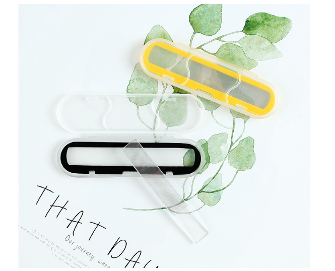 Yellow and black nano glass files displayed with fresh green mint leaves and soft apricot accents, in a salon‑ready arrangement