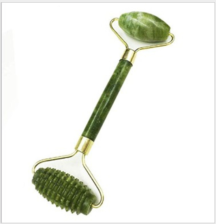 Green jade roller with textured massage head and smooth oval head, brass accents