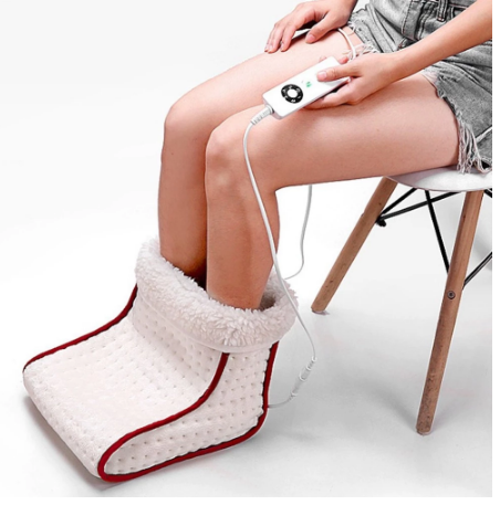 Woman using the heated foot warmer massager with remote control on her lap, demonstrating comfortable positioning and ease of use