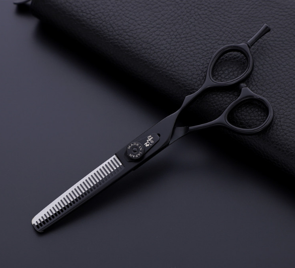 Black thinning shear with toothed blade and finger rings