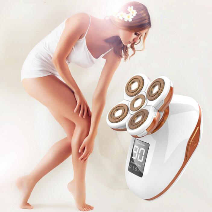 Woman holding electric shaver while grooming leg