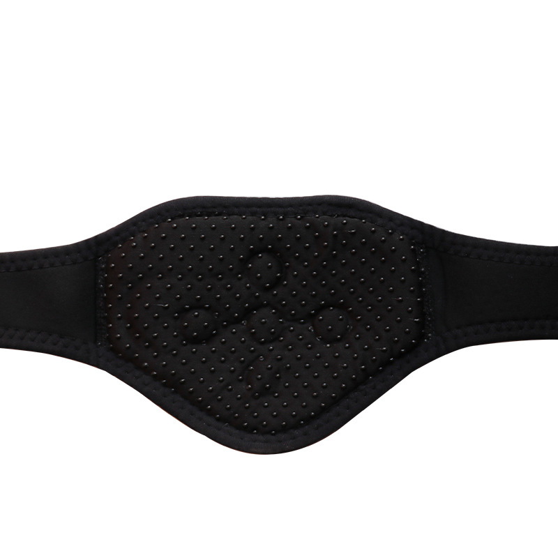 Flat lay of neck protector with straps extended, glowing softly to suggest warmth and magnetic energy