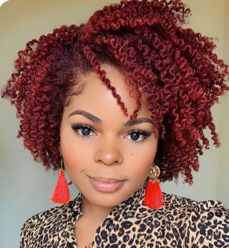 Woman wearing burgundy short curly wig
