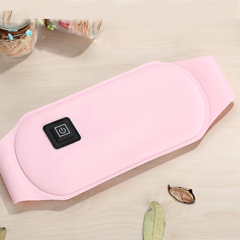 Top-down view of pink heating belt showing ergonomic contoured shape and power button