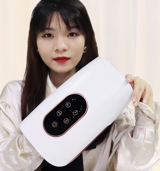 Smart hand massager with digital touchscreen displaying emoji modes, held by woman, showing compact premium design