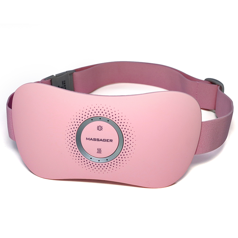 Front angled view of pink heating waist belt with adjustable straps and metallic gray control dial on soft lilac acrylic surface