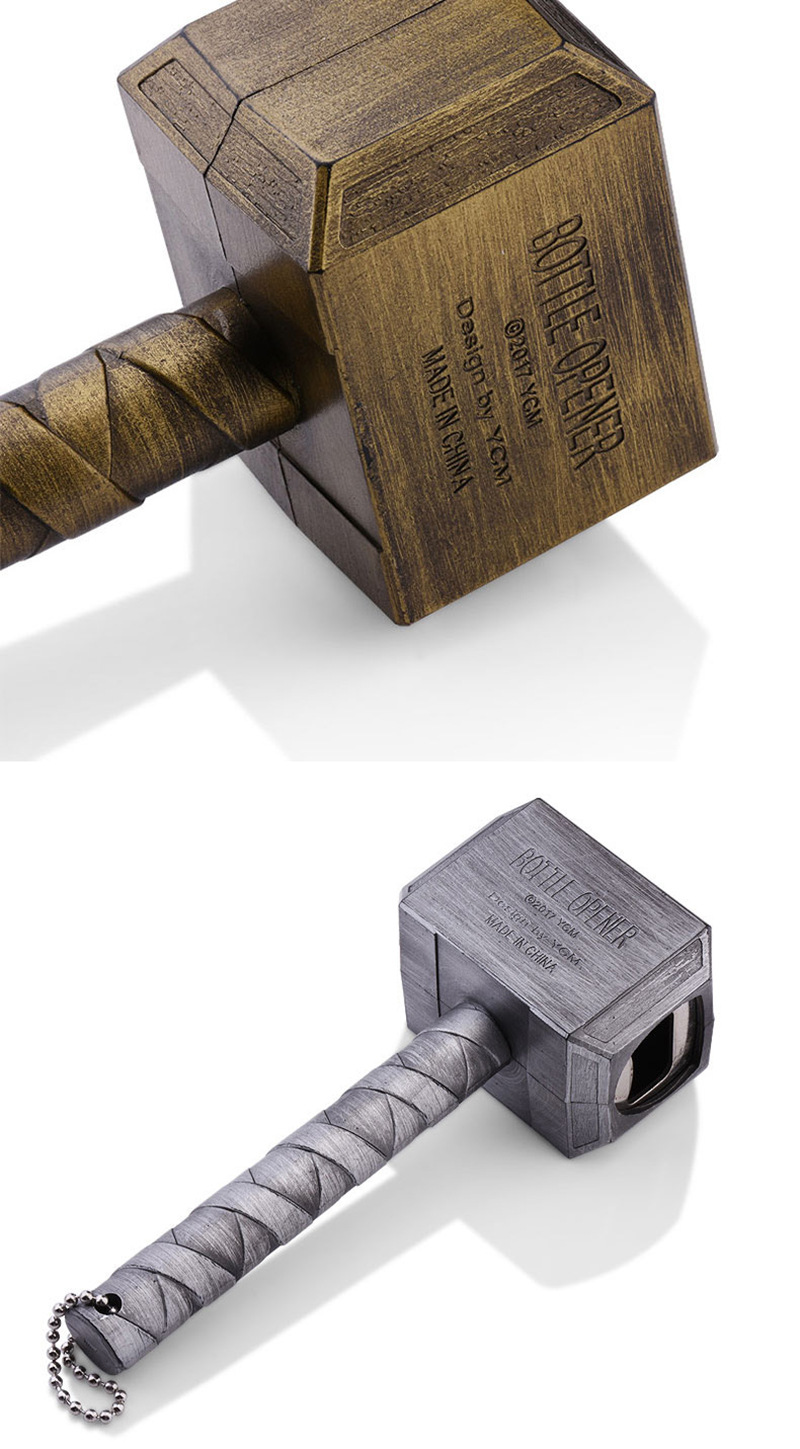 Hand holding a bronze hammer opener with the wrapped handle visible