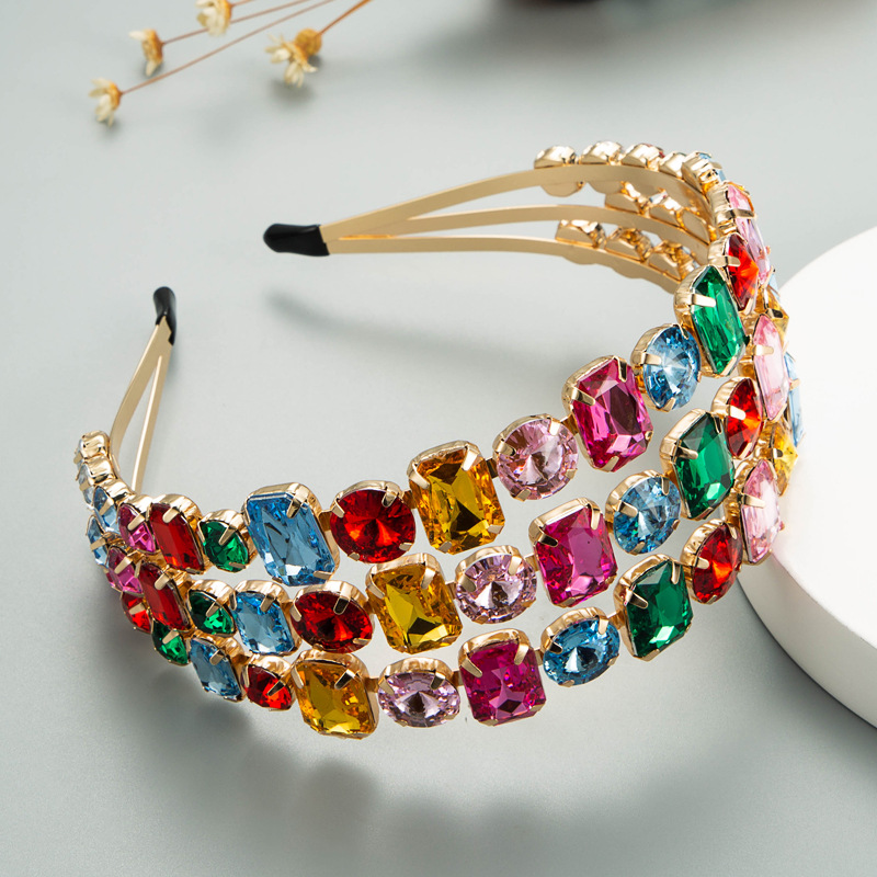 Colorful crystals arranged along polished gold-tone frame