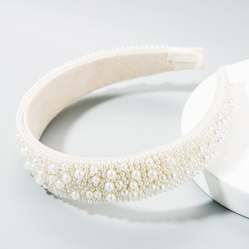 Three-quarter view of wide padded pearl headband