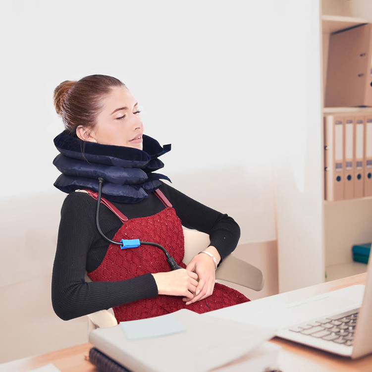 Woman at a desk with neck discomfort, reaching for relief before using the traction device.