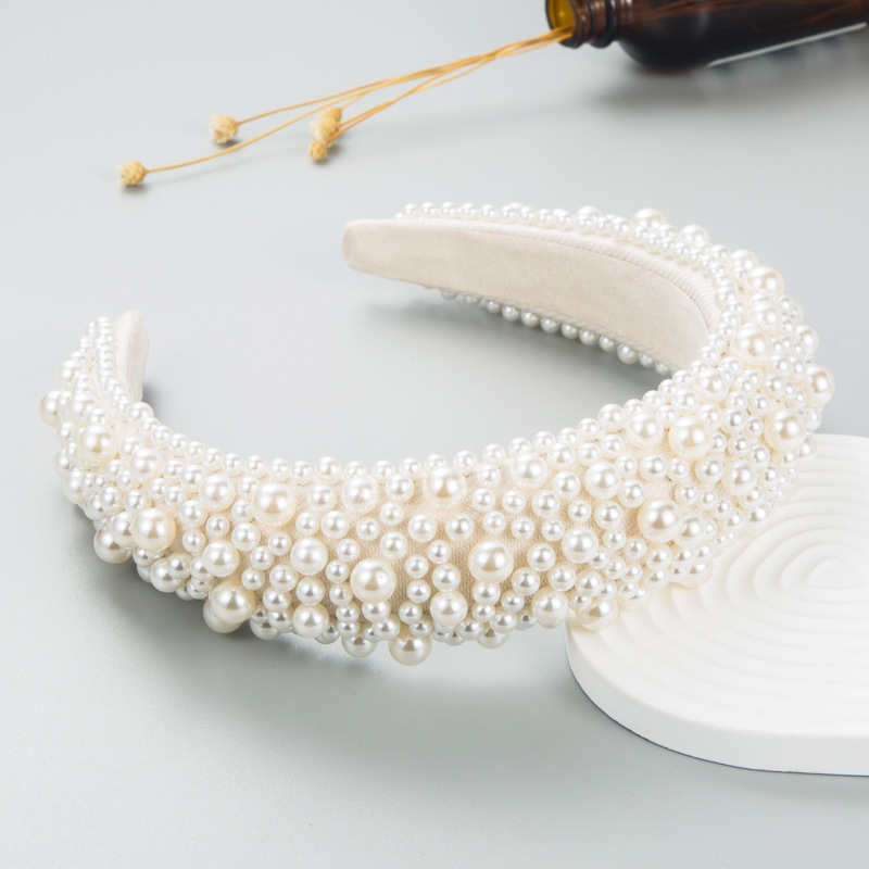Layered faux pearls across ivory padded headband