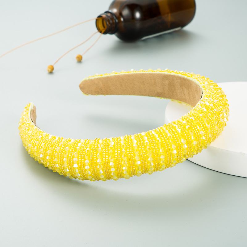 Bright yellow hoop styled with flowers and bottle