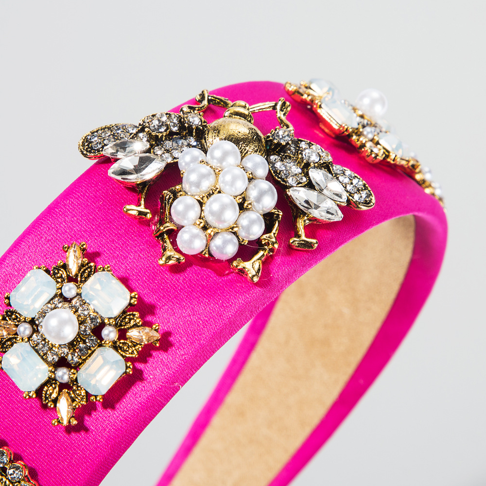 Close view of pink headband pearls rhinestones and bee