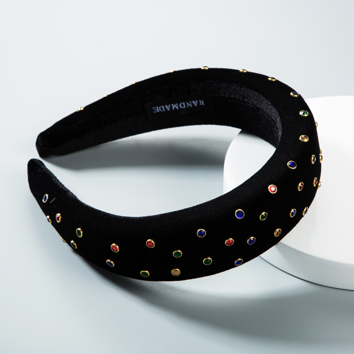 Black velvet headband with padded fabric-covered inner edge