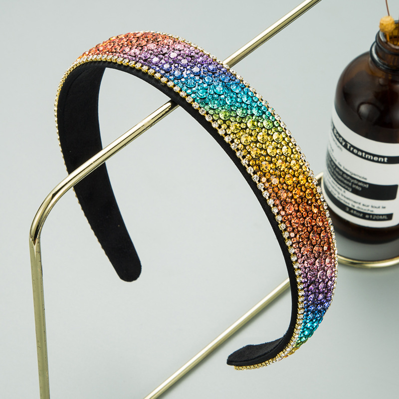 Rainbow gradient rhinestone headband on gold stand