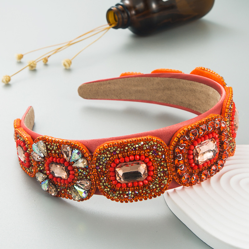 Orange hoop displaying dense crystal and pearl embellishment