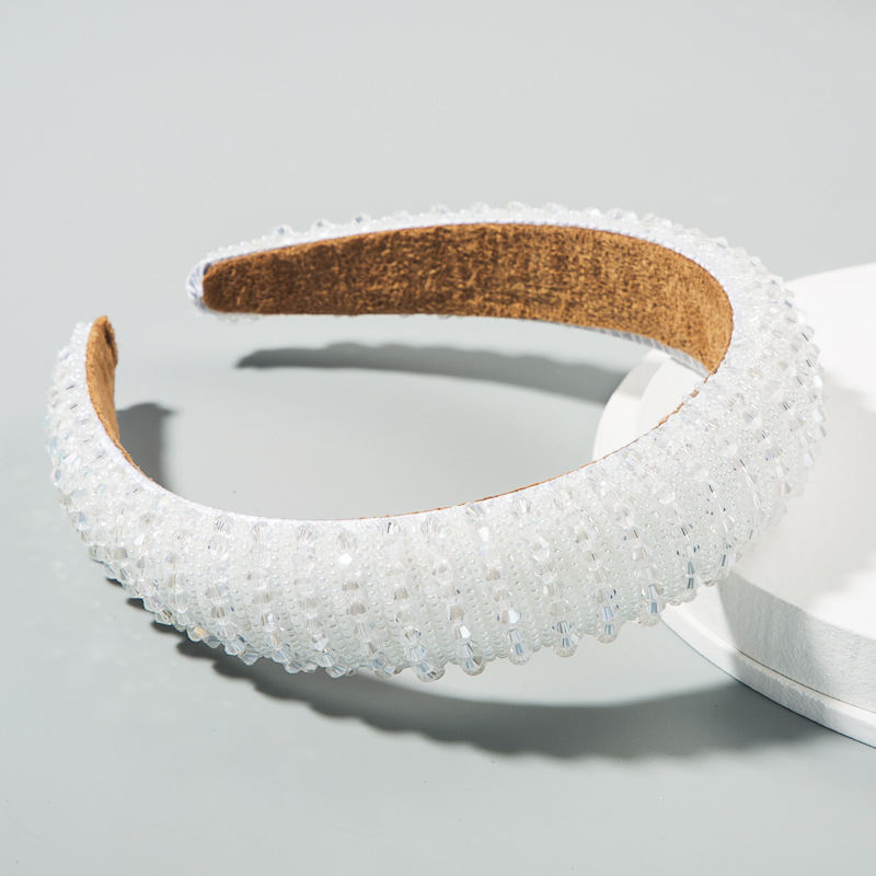 Soft inner lining beneath a white beaded hoop
