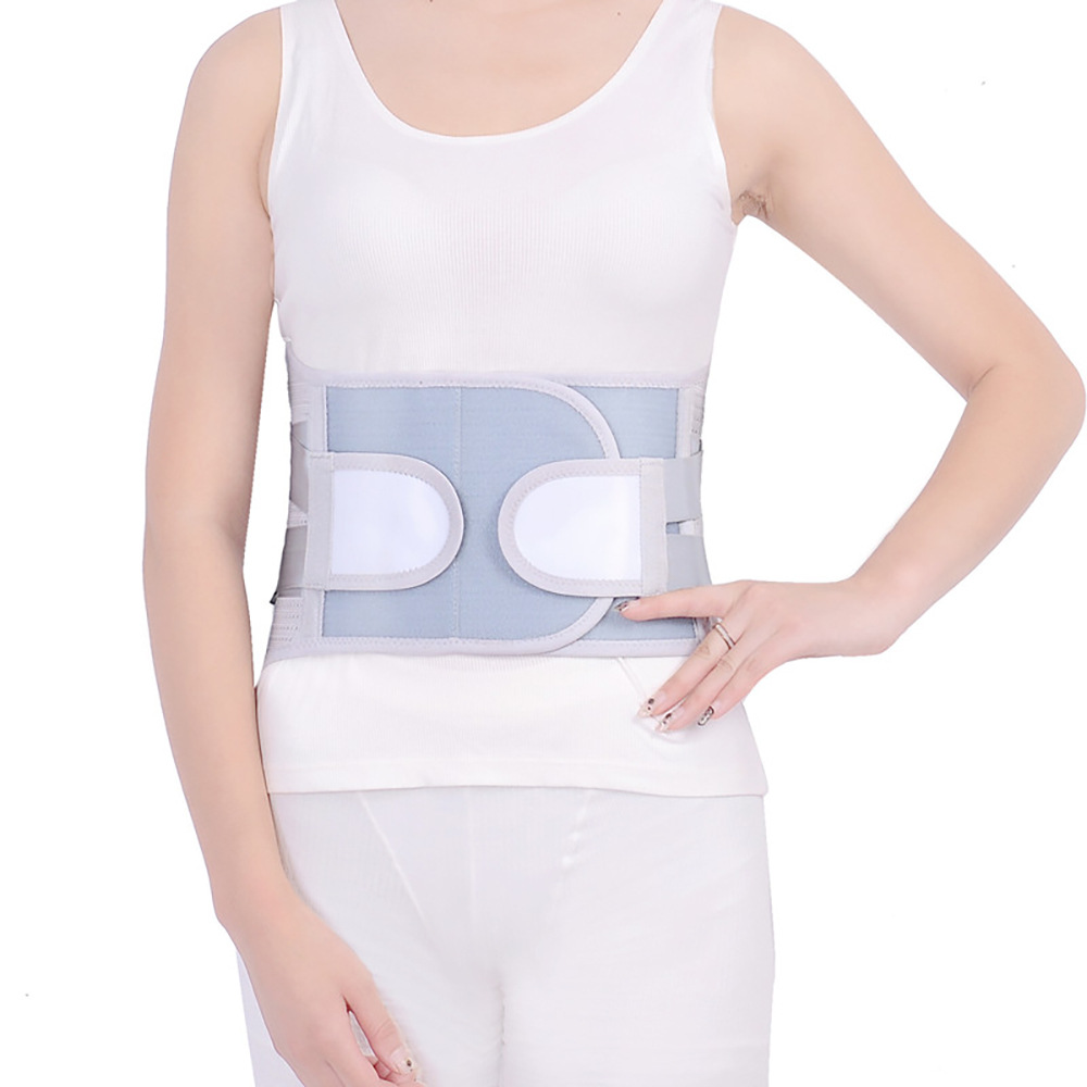 Woman wearing complete white orthopedic belt under fitted white tank top, showing discrete, professional appearance
