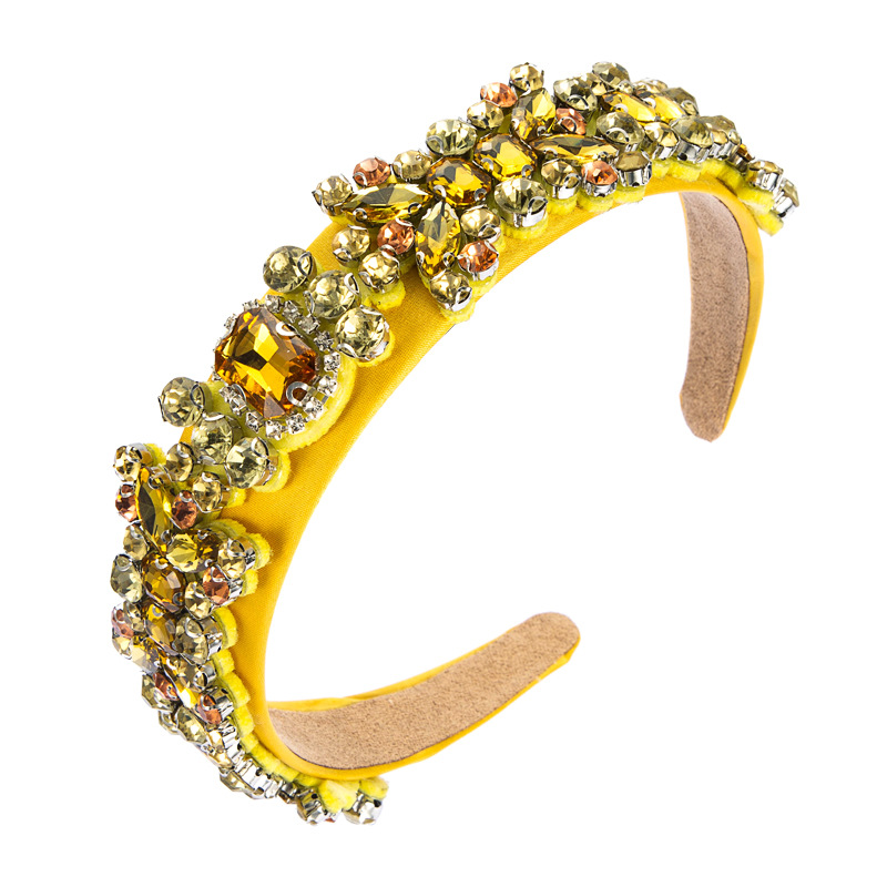 Yellow headband covered in glossy faceted rhinestones