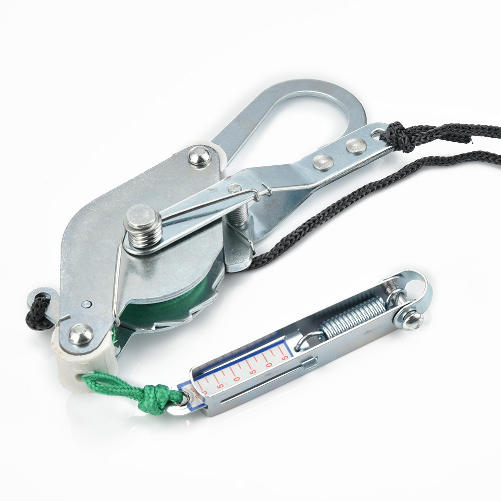 Close-up of steel carabiner clip, pulley mechanism, adjustable straps, and integrated pressure gauge with measurement scale