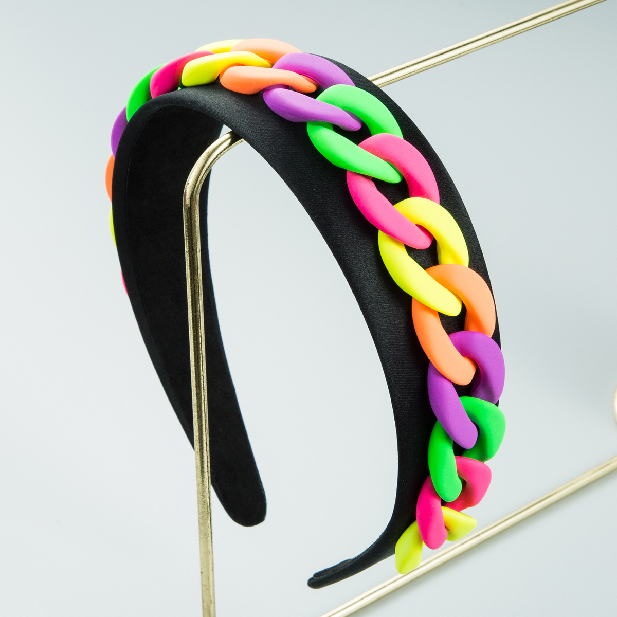 Black structured headband with bright chain embellishment