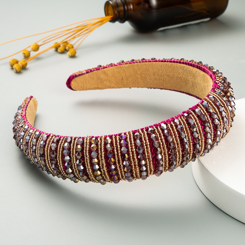 Close view of layered burgundy bronze beadwork