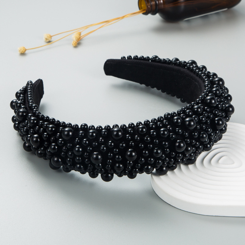 Black wide headband showing structured open silhouette