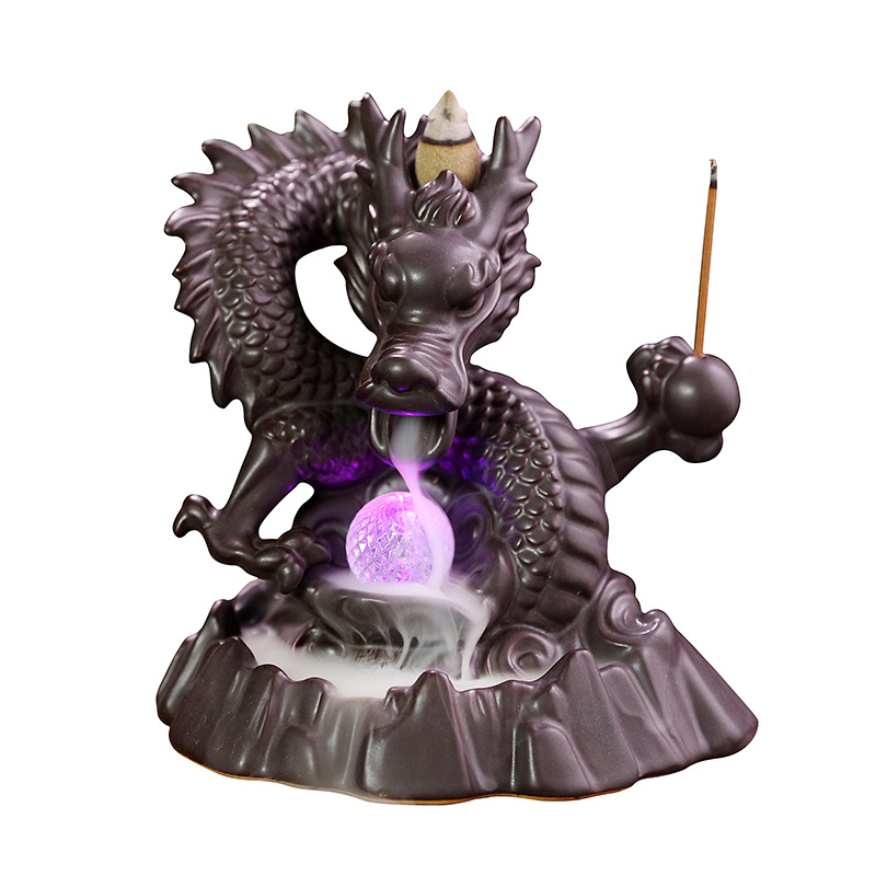 Elevate your home decor with our Ceramic Chinese Dragon Backflow Incense Burner. Watch as the intricately designed dragon releases a soothing flow of smoke, creating a serene atmosphere. Handcrafted from ceramic, this burner adds a touch of elegance and tradition to any space. Perfect for relaxation and meditation.