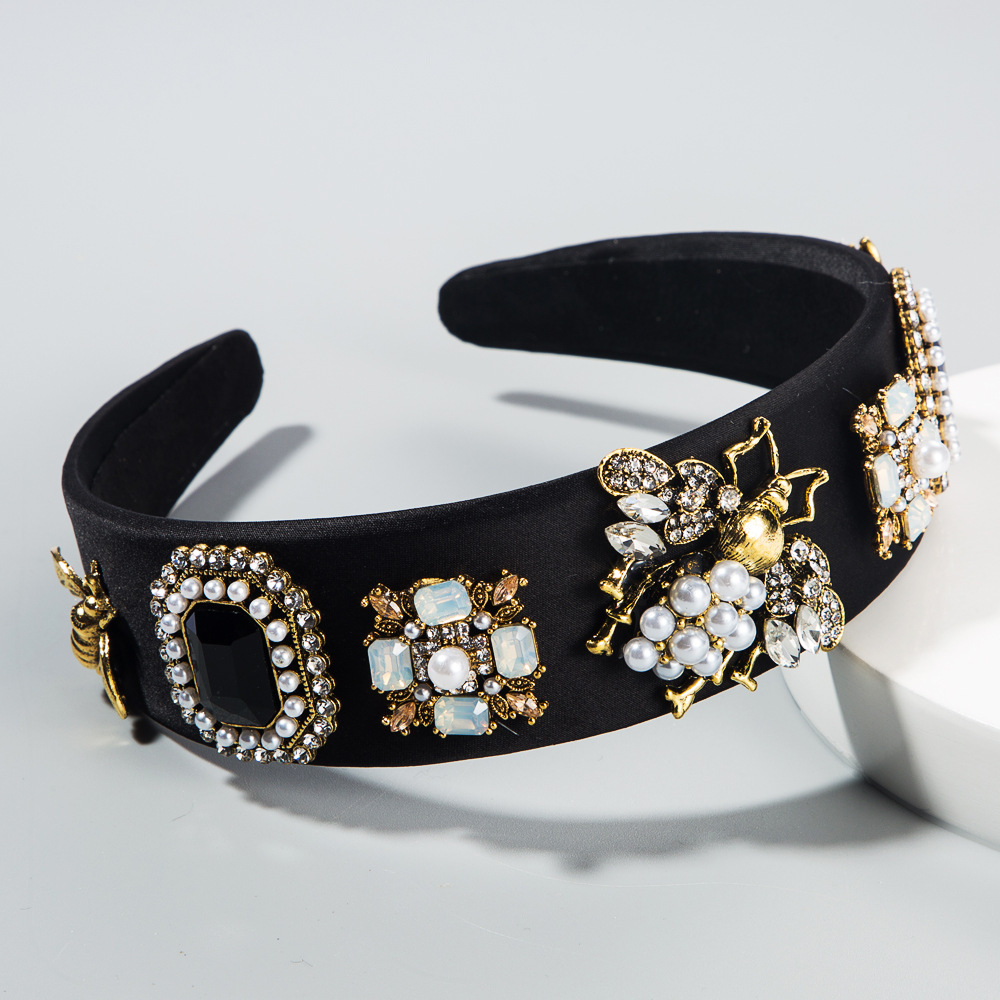 Black padded headband showing soft lining and ornamentation