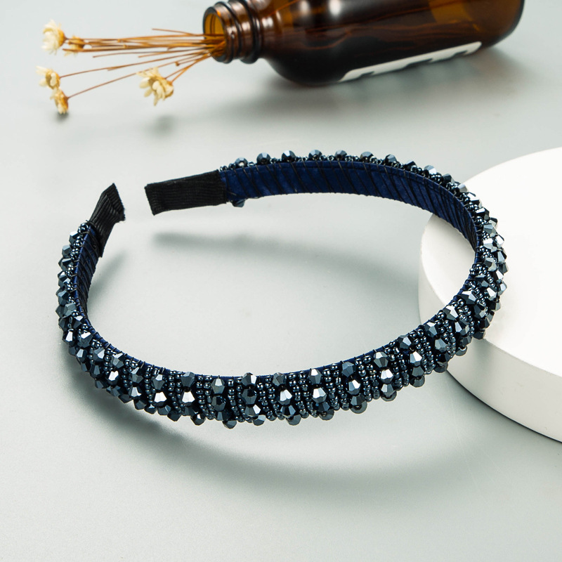 Navy beaded headband worn as a polished accessory