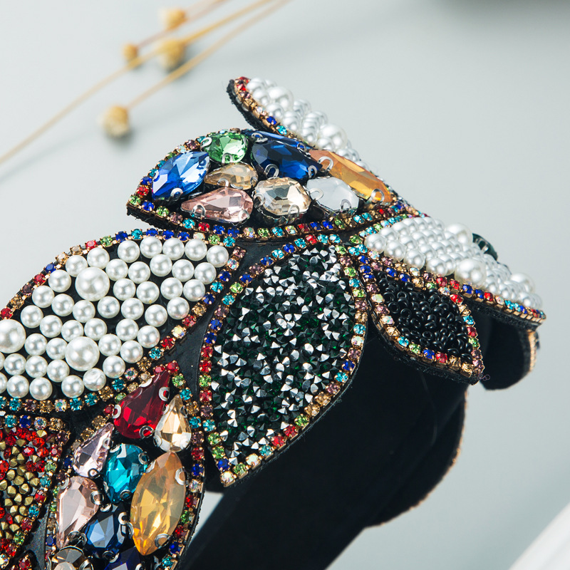 Black headband close-up with pearls rhinestones and gems