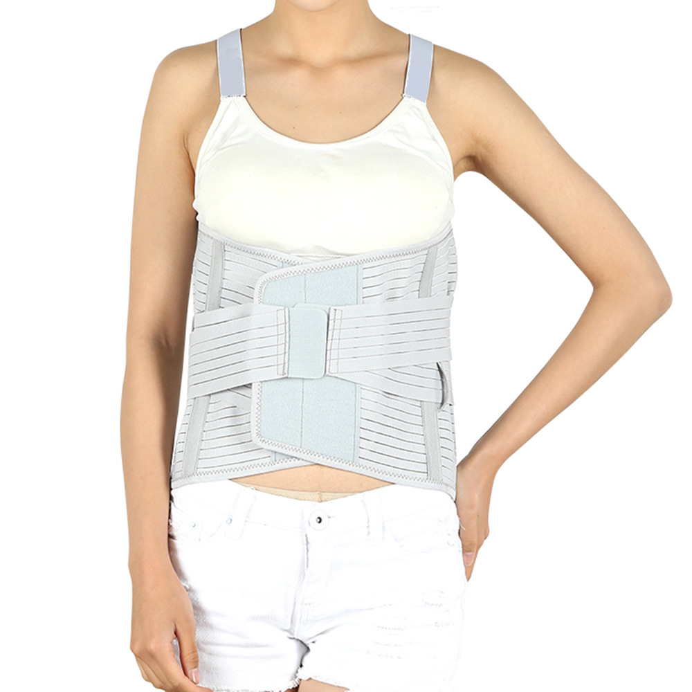 Woman wearing light gray lumbar support belt with dual compression straps and steel plate reinforcement, demonstrating proper fit and ease of movement