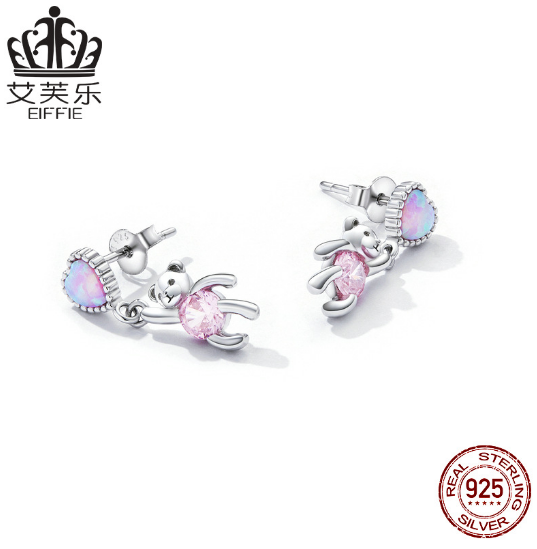 These earrings feature a unique design: a sterling silver heart shape with opal accents and a small bear engraved into the heart. Crafted from durable sterling silver, the earrings are finished with a bright polished shine and secure latch closure. Show off your style with this one-of-a-kind design and the long-lasting shine of sterling silver.